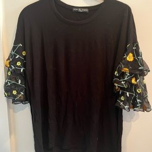 Black blouse and multicolored sleeves from Kim and Cami